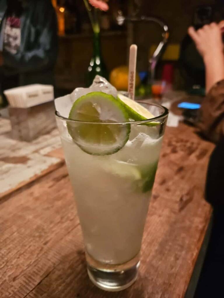 Spanish guests sample drinks at the bar during a drinking tour