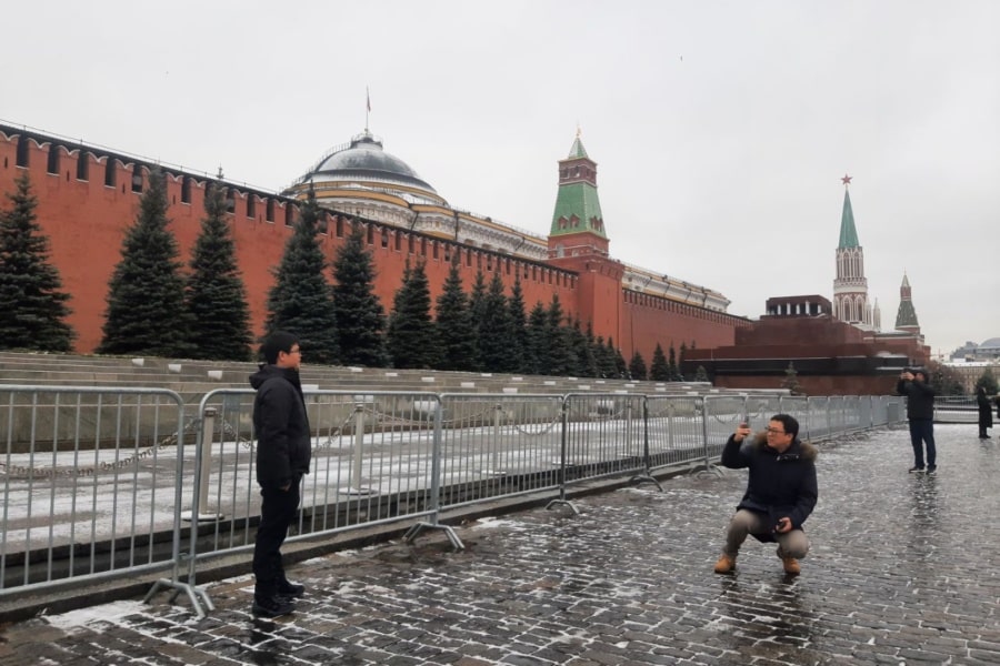 Chinese guests take pictures of each other on Red Square