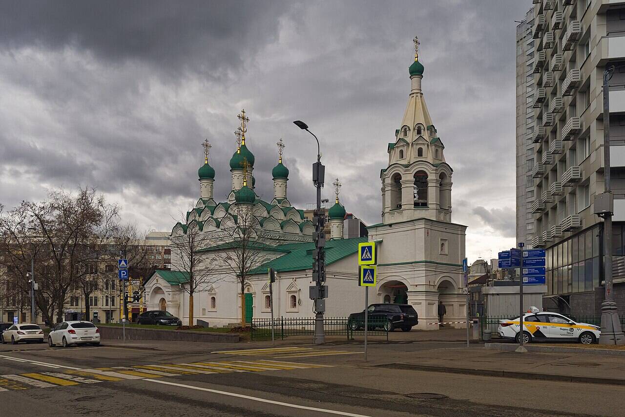 The Church of St Simeon the Stylite on Povarskaya Street, with its bell tower and green domes against a modern building