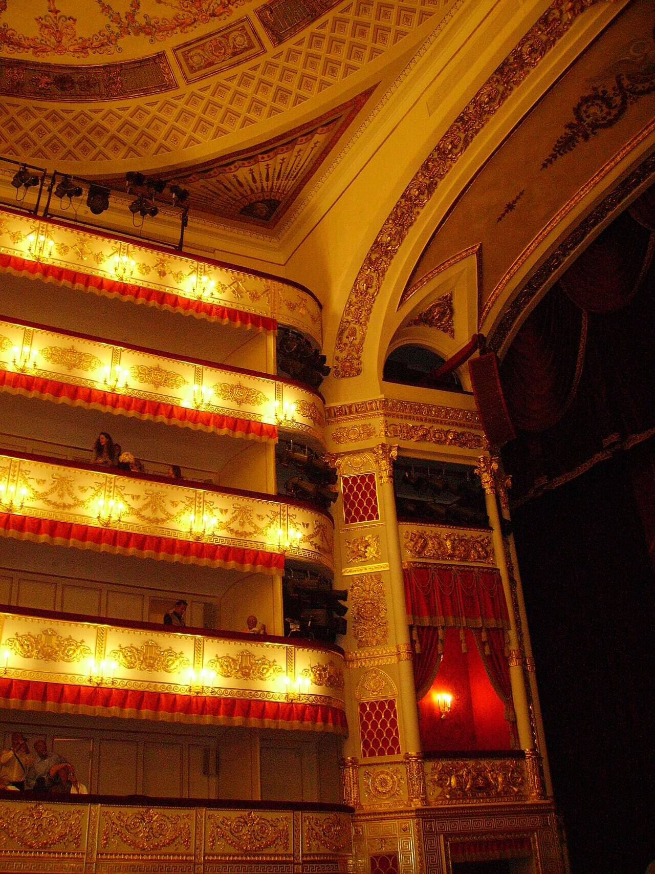 Tiers of boxes with gilded decoration, the proscenium arch and the painted auditorium ceiling at the Alexandrinsky Theatre