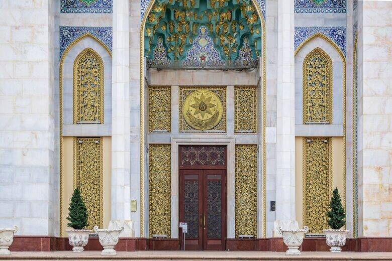 The entrance to the Azerbaijan Pavilion: colourful ornamentation above the door and golden grilles on either side.