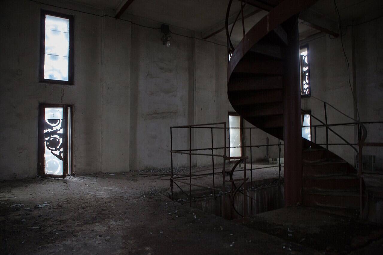 A metal spiral staircase in the technical area on the second tier of the Central Pavilion at VDNKh