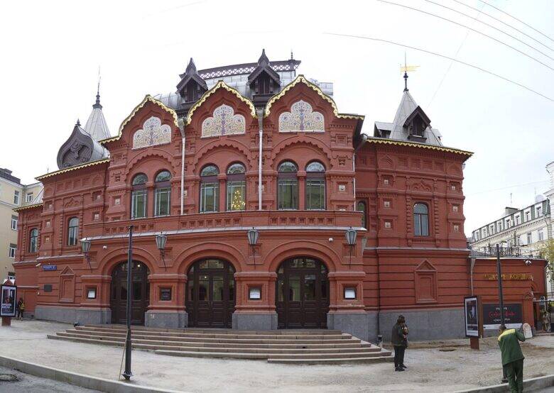 The red-brick façade of the former Korsh Theatre, with arched entrances and decorative pediments.