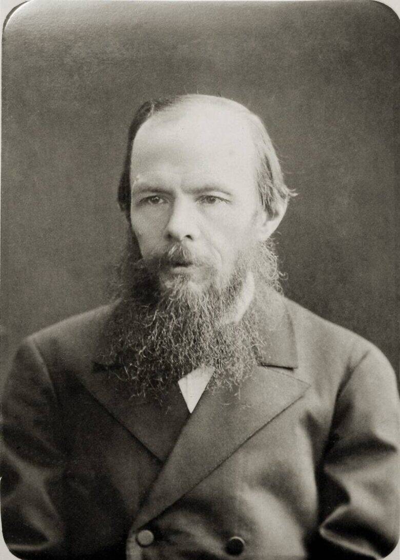 Black-and-white waist-length photographic portrait of Fyodor Dostoevsky with a beard