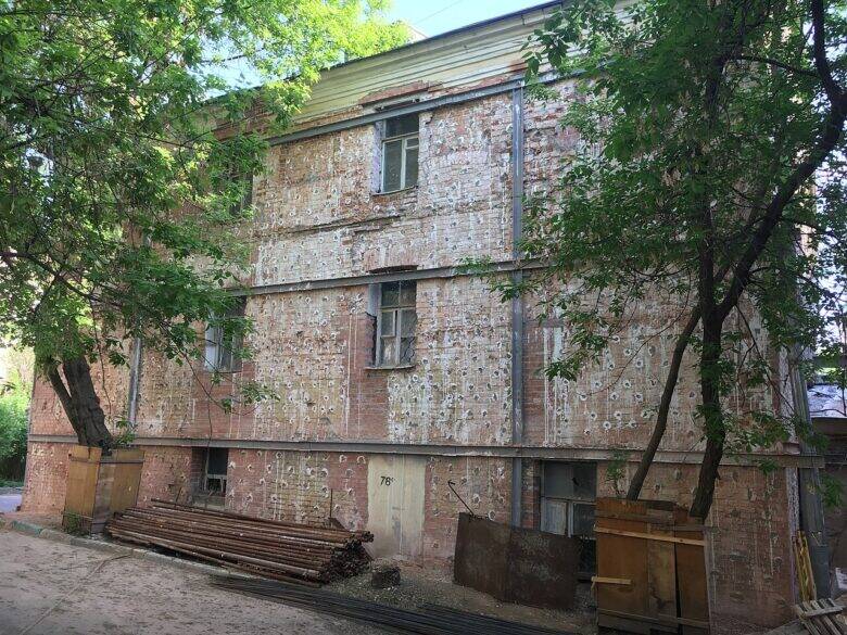 The brick façade of the main house of the Lopukhin–Kiryakov estate behind the trees.