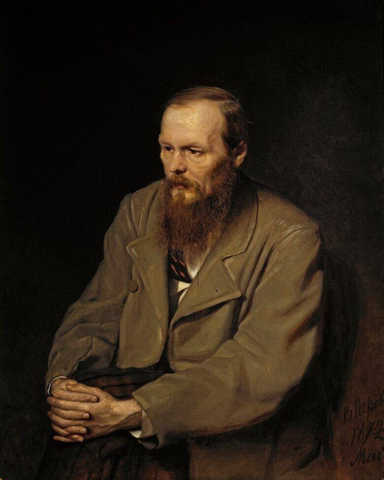 Dostoevsky sits against a dark background, his gaze lowered and his hands clasped on his knee.