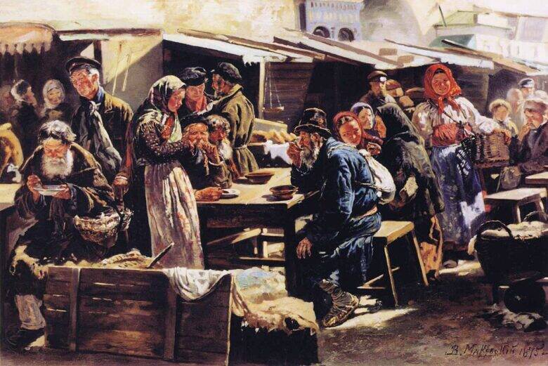 People eating at a wooden table among market awnings; crates and belongings lie in the foreground.